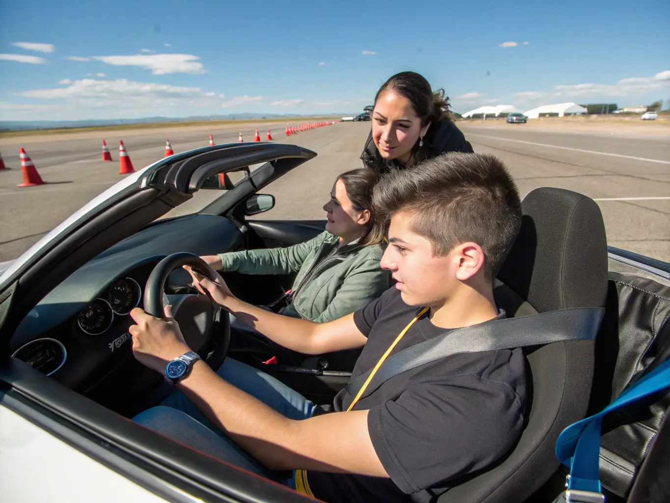 A dynamic photo of an instructor guiding adult participants during a drift driving training session on a closed track, with safety cones and a UDC banner visible in the background.